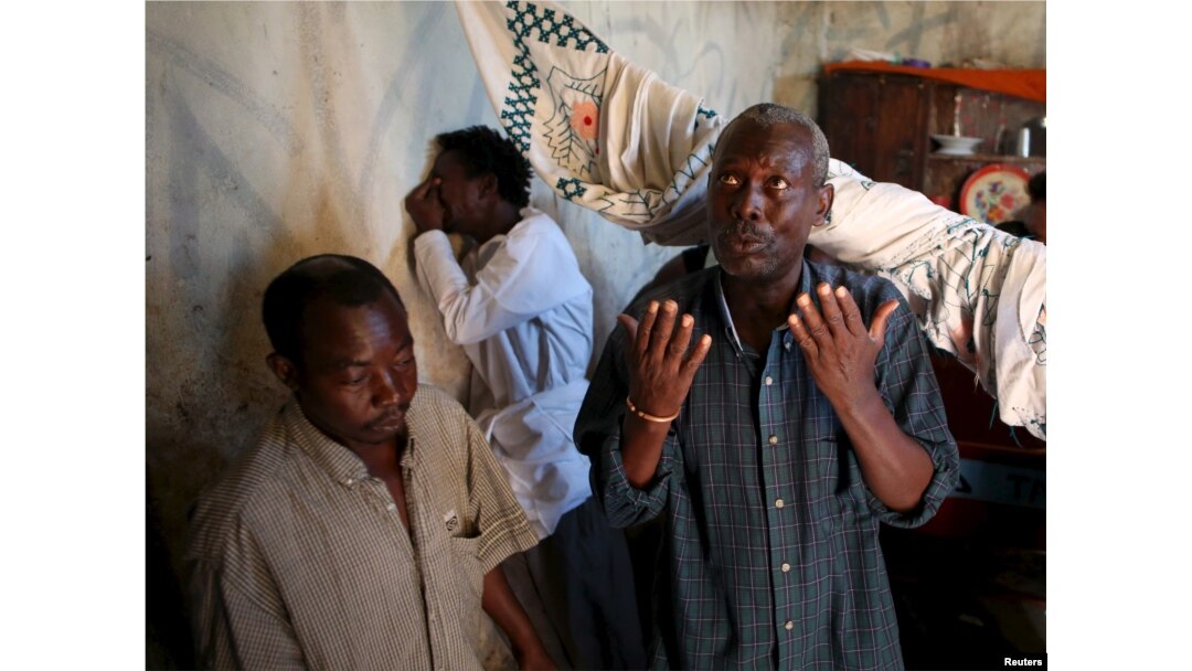 FILE - Family and friends weep and pray after preparing the body for burial of Ndayizeye Janvier Abdul, who they say was killed by members of the Imbonerakure, in the district of Buterere in Bujumbura, Burundi, June 3, 2015.