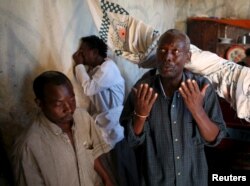 FILE - Family and friends weep and pray after preparing the body for burial of Ndayizeye Janvier Abdul, who they say was killed by members of the Imbonerakure, in the district of Buterere in Bujumbura, Burundi, June 3, 2015.