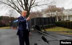 U.S. President Donald Trump answers questions in front of the West Wing of the White House as he departs to attend a briefing at the National Institutes of Health Vaccine Research Center, March 3, 2020.