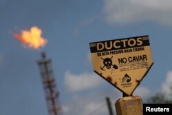 FILE - A sign is pictured of Mexico's national oil company Pemex's refinery in Salamanca, in Guanajuato state, Mexico, Sept. 19, 2017.