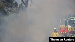 New South Wales Rural Fire Service personnel conduct a controlled burn to eliminate fuels before the upcoming bushfire season in the Arcadia suburb of Sydney, Australia, Sept. 8, 2020.