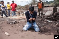 Bryan Rivera cries after looking at the remains of his house, after his family went missing during the Volcan de Fuego or "Volcano of Fire" eruption, in San Miguel Los Lotes, Guatemala, June 7, 2018.