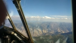 In this file photo, a thin layer of cumulus clouds caps dense smoke from the Kiawah-Rabbit Foot fires in eastern Idaho during August 2018. The image was captured from the scientists’ C-130 research plane. (Photo Credit: Emily V. Fischer/American Geophysical Union)