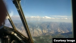 In this file photo, a thin layer of cumulus clouds caps dense smoke from the Kiawah-Rabbit Foot fires in eastern Idaho during August 2018. The image was captured from the scientists’ C-130 research plane. (Photo Credit: Emily V. Fischer/American Geophysical Union)