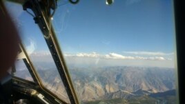 In this file photo, a thin layer of cumulus clouds caps dense smoke from the Kiawah-Rabbit Foot fires in eastern Idaho during August 2018. The image was captured from the scientists’ C-130 research plane. (Photo Credit: Emily V. Fischer/American Geophysical Union)