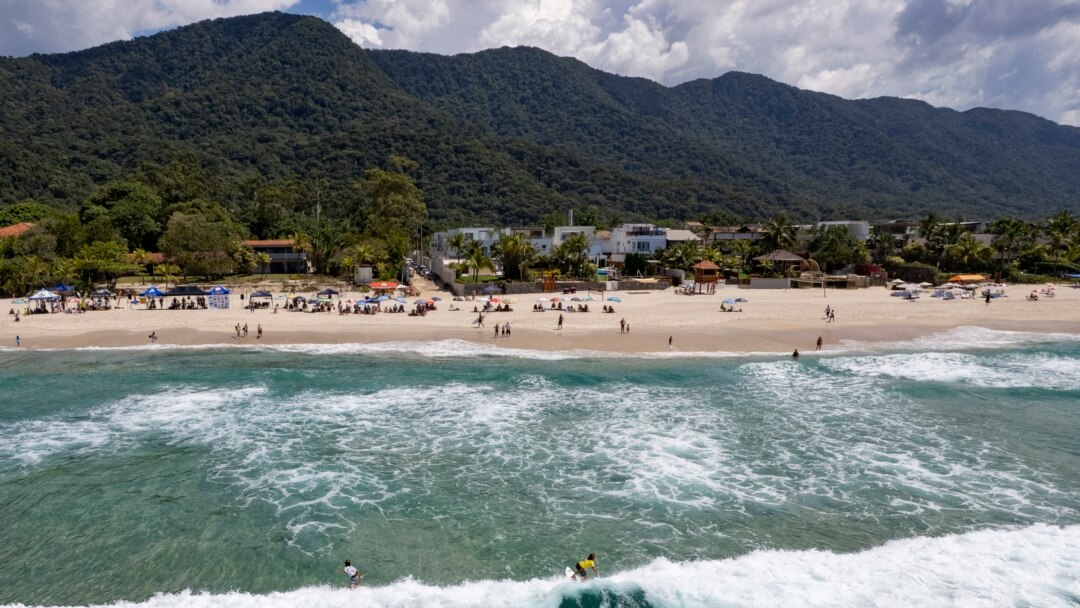 Surfers enjoy the waves during a local tournament at Maresias beach, in Sao Sebastiao, Brazil, Nov. 27, 2021.