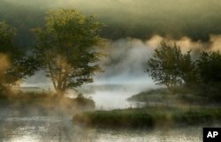 In this Aug. 10, 2017, photo, fog rises from the Penobscot River's East Branch in the Katahdin Woods and Waters National Monument near Patten, Maine.