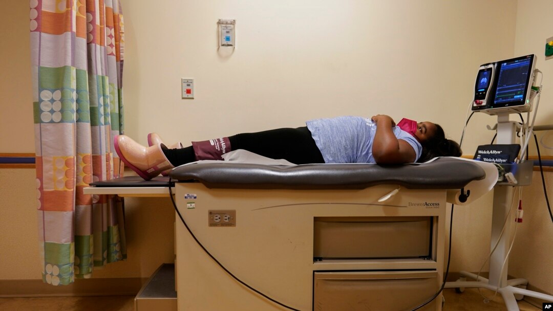 Brooklynn Chiles, 8, lies on an exam room table during a followup visit to Children's National Hospital in Washington, Feb. 11, 2022.