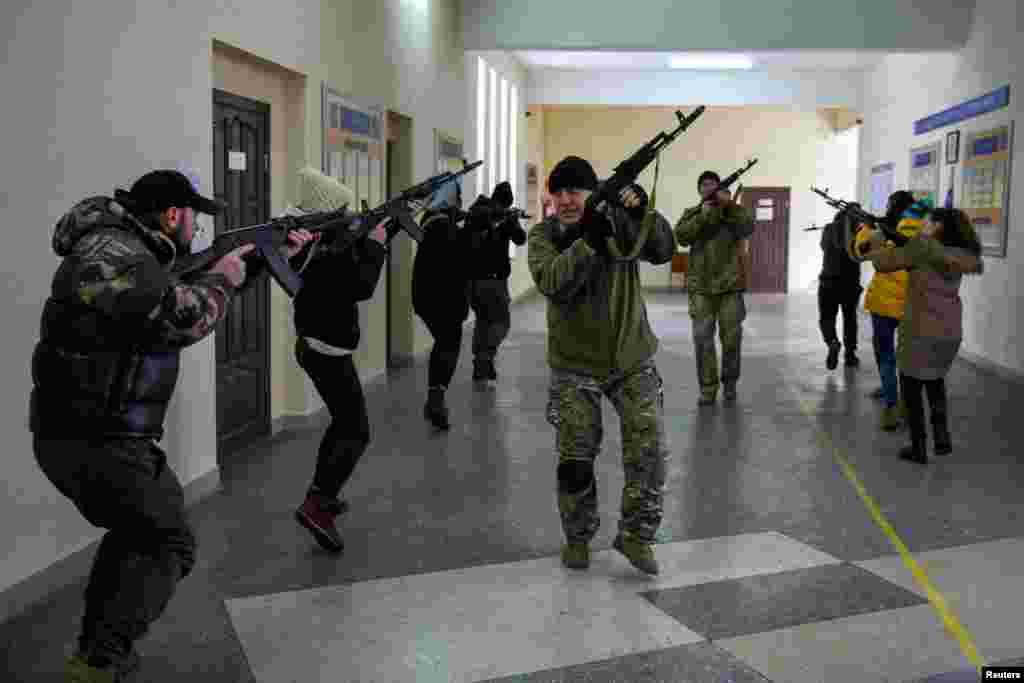 Civilians who volunteered to join the Territorial Defence Forces train on weapons, following Russia&#39;s invasion of Ukraine, in Odessa, Ukraine.