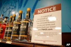 FILE - A sign in the vodka area of a Pennsylvania Fine Wine and Good Spirits store reflects the state's decision to withdraw Russian-made products for sale, in Harmony, Pa., Feb. 28, 2022.