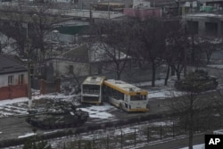 Russian's army tanks move down a street on the outskirts of Mariupol, Ukraine, March 11, 2022.