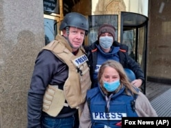 This image released by Fox News Channel shows Fox News correspondent Steve Harrigan, left, with Jerusalem-based senior producer Yonat Friling, foreground, and senior field producer Ibrahim Hazboun. Friling has been on assignment covering the Russian invas