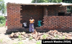 A victim of Tropical Storm Ana- Margret Samson standing outside her flood-hit house in Phalombe district, Malawi, Feb 3, 2022.