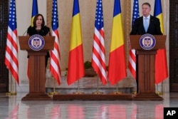 US Vice President Kamala Harris holds a joint press conference following a meeting with Romanian President Klaus Iohannis, right, at Cotroceni Palace in Otopeni, Romania, March 11, 2022.