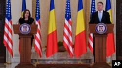 US Vice President Kamala Harris holds a joint press conference following a meeting with Romanian President Klaus Iohannis, right, at Cotroceni Palace in Otopeni, Romania, March 11, 2022.