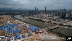 An aerial view shows the construction site for COVID-19 isolation facilities and a temporary bridge linked between China's Shenzhen and Hong Kong's Lok Ma Chau, March 11, 2022.