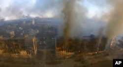 This image taken from video provided by Azov Battalion shows an aerial view of burned out high-rise buildings in Mariupol, Ukraine, March 14, 2022. (Azov Battalion via AP)