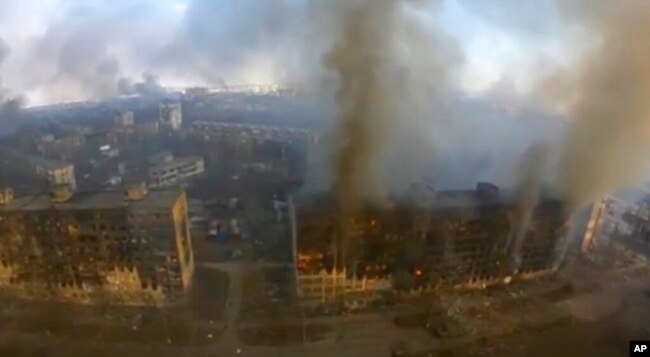 This image taken from video provided by Azov Battalion shows an aerial view of burned out high-rise buildings in Mariupol, Ukraine, March 14, 2022. (Azov Battalion via AP)