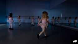 Alyssa Carpenter, 2, runs around in tap shoes during "Dance Part" at Tiny Tot ballet and tap class at Lyrique Dance in Warrenton, Va., Jan. 15, 2022. Alyssa has had COVID-19 twice and suffers long-term symptoms.