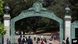 FILE - Students walk past Sather Gate on the University of California at Berkeley campus in Berkeley, Calif., May 10, 2018. 