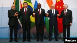 Indian Prime Minister Narendra Modi, China's President Xi Jinping, South Africa's President Cyril Ramaphosa, Russia's President Vladimir Putin and Brazil's President Michel Temer pose for a group picture at the BRICS summit meeting in Johannesburg, South 