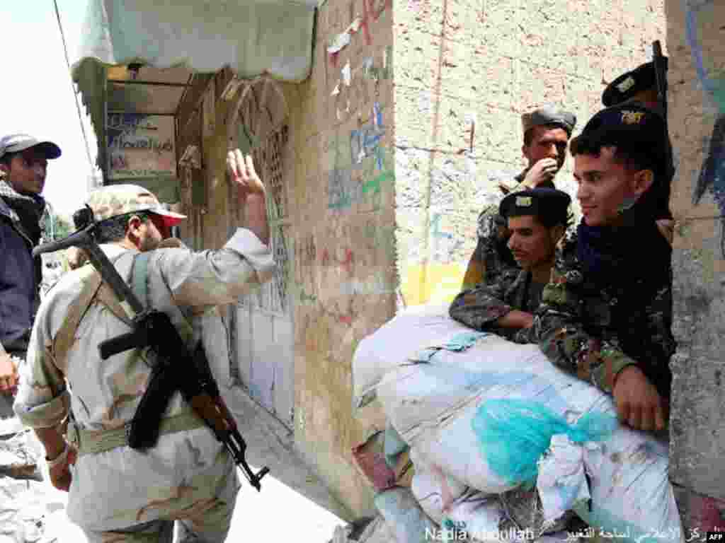 A soldier waves to other security forces members. (Photo - Nadia Abdullah)