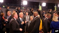 U.S. Defense Secretary Lloyd Austin, center, speaks with NATO Secretary-General Jens Stoltenberg, front second left, during the North Atlantic Council meeting of NATO defense ministers at NATO headquarters in Brussels, March 16, 2022. Stoltenberg has made it clear that the 30-nation military alliance is set to radically change its security stance in Europe in response to Russia's war on Ukraine.