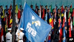 FILE - The FINA flag is raised during the opening ceremony at the World Swimming Championships in Gwangju, South Korea, July 12, 2019.