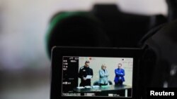 Russian opposition leader Alexei Navalny, accused of fraud and contempt of court, his lawyers Olga Mikhailova and Vadim Kobzev are seen in the viewfinder of a TV camera during a court hearing at the IK-2 corrective penal colony in the town of Pokrov in Vladimir Region, Russia March 22, 2022.