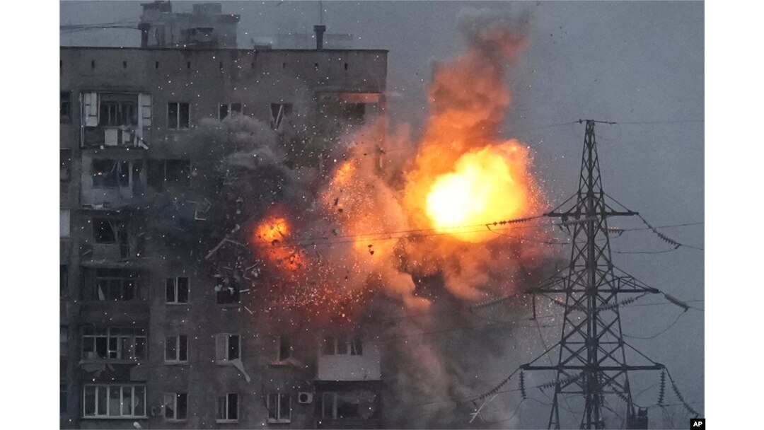 An explosion in an apartment building that came under fire from a Russian army tank in Mariupol, Ukraine, March 11, 2022.