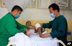 FILE - An Afghan boy receives medical care at the International Committee of the Red Cross physical rehabilitation center after being injured in fighting between the Taliban and Afghan security personnel, in Kabul, Afghanistan, Aug. 10, 2021.