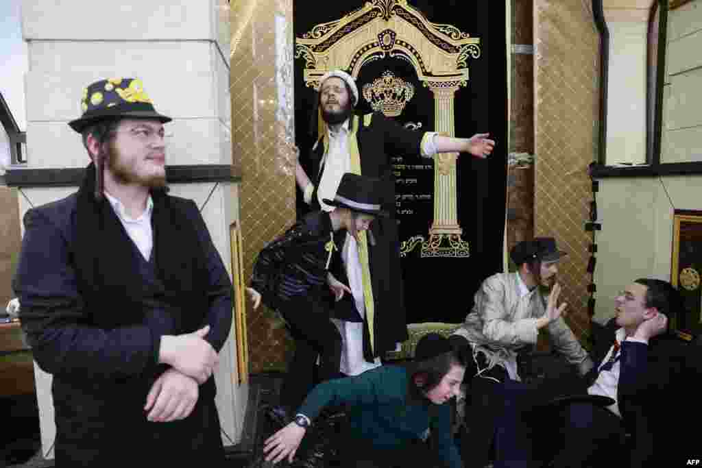 Jewish men and young people in Purim clothes celebrate in the Mea Shearim ultra-Orthodox neighborhood in Jerusalem.
