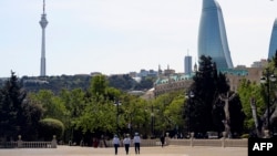 FILE - Police officers patrol in Baku, Azerbaijan, May 18, 2020.