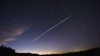 FILE - In this file photo taken Feb. 7, 2021, a long-exposure image shows a trail of a group of SpaceX's Starlink satellites passing over Uruguay as seen from the countryside some 185 kilometers north of Montevideo.