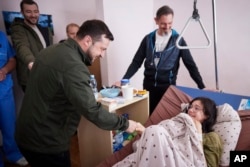 President Volodymyr Zelenskyy visits the wounded in a hospital in Kyiv, Ukraine, March 17, 2022. (Ukrainian Presidential Press Office via AP)