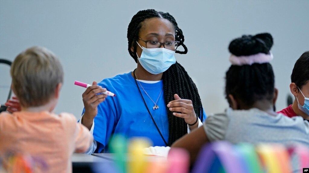 Kiara Beard works with children in a before- and afterschool program operated by the YMCA of Middle Tennessee in Wednesday, March 16, 2022, in Nashville, Tenn. 