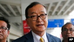 FILE - Cambodia's exiled opposition leader Sam Rainsy talks to the media upon arrival at Soekarno-Hatta International Airport in Tangerang, Indonesia on Nov. 14, 2019. 