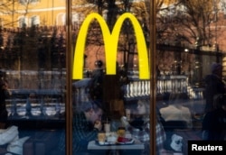 People eat in a McDonald's restaurant near Kremlin in central Moscow, Russia, March 9, 2022.