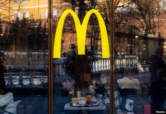 People eat in a McDonald's restaurant near Kremlin in central Moscow, Russia, March 9, 2022.