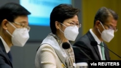 Hong Kong's Chief Secretary John Lee, Hong Kong Chief Executive Carrie Lam and Hong Kong Financial Secretary Paul Chan attend a news conference in Hong Kong, China, March 21, 2022.