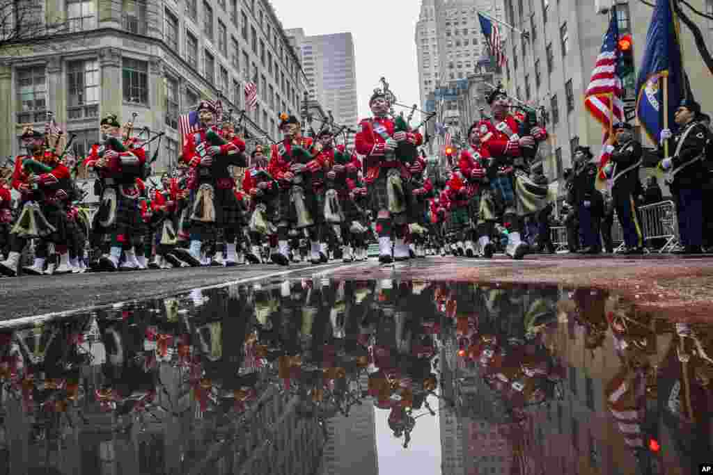 Bagpipers march up Fifth Avenue past St. Patrick Cathedral during the St. Patrick&#39;s Day Parade in New York.