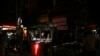 Street food vendors wait for customers during a power outage in Yangon, Myanmar, March 3, 2022. 