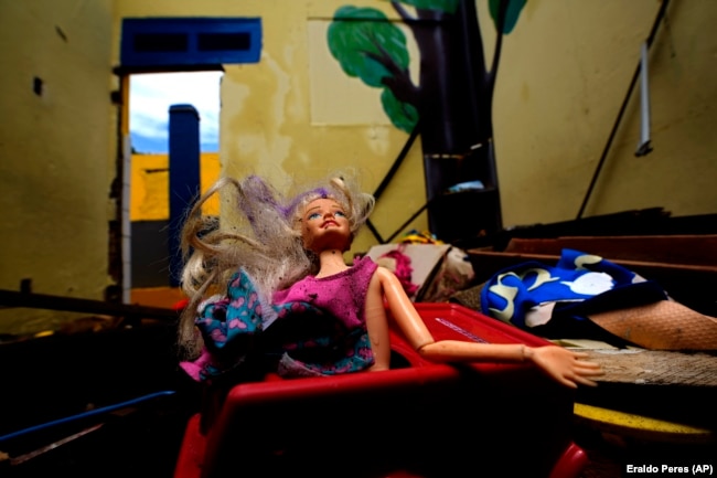 A Barbie doll lays in a classroom of an abandoned school in the Pinheiro neighborhood of Maceio, Alagoas state, Brazil, March 6, 2022. (AP Photo/Eraldo Peres)