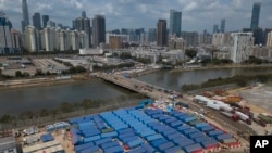 An aerial view shows a construction site for coronavirus isolation facilities and a temporary bridge linked China's Shenzhen and Hong Kong's Lok Ma Chau cities in Hong Kong, March 11, 2022.