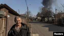 A man walks at a residential district that was damaged by shelling, as Russia's invasion of Ukraine continues, in Kyiv, Ukraine March 23, 2022.