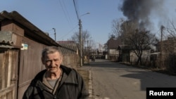 A man walks in a residential district that was damaged by shelling, as Russia's invasion of Ukraine continues, in Kyiv, Ukraine, March 23, 2022.