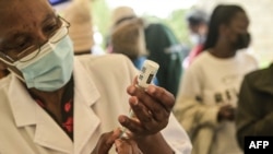 FILE: A healthcare worker prepares a dose of Moderna Covid-19 vaccine, during a mass vaccination in Nairobi, on 12.16.2021