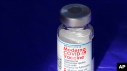 FILE - In this March 4, 2021, photo, a vial of the Moderna COVID-19 vaccine rests on a table at a drive-up mass vaccination site in Puyallup, Wash.