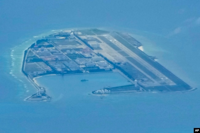 Chinese structures and buildings at the man-made island on Mischief Reef at the Spratlys group of islands in the South China Sea are seen on Sunday March 20, 2022. (AP Photo/Aaron Favila)