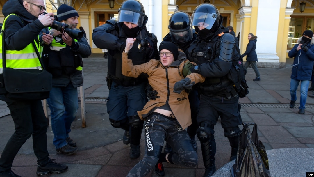 Police officers detain a man during a protest against Russian military action in Ukraine, in central St. Petersburg, Russia, March 13, 2022.
